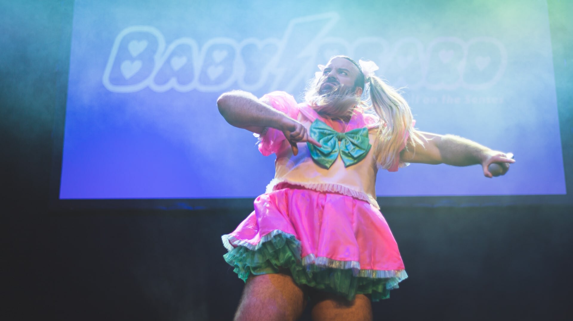 Ladybeard performing on stage in a colorful outfit at the MEX Anime Convention 2024.